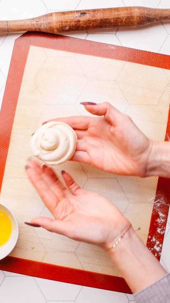 Coil the paratha dough into a circle.