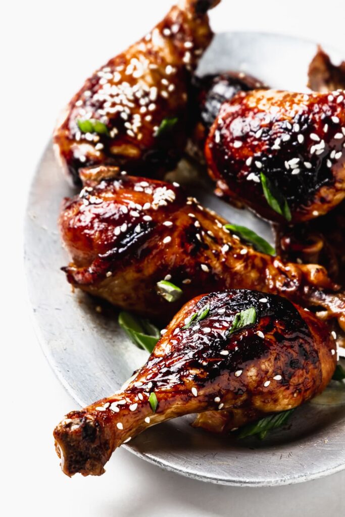 Sesame Soy Chicken Drumsticks stacked on a small plate
