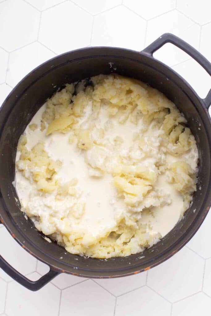 The mashed potatoes are covered with the warm cream and butter mixture