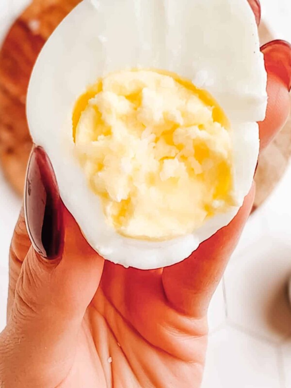How to boil eggs in the microwave: showing the last step, peeling the microwave-boiled egg.