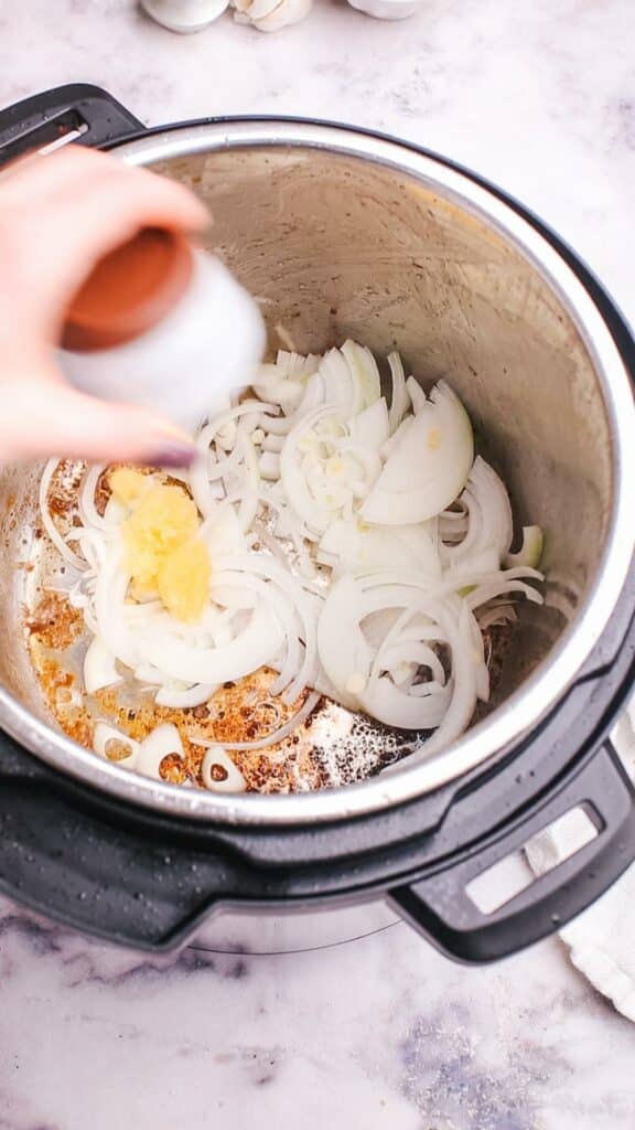 adding onion to pot