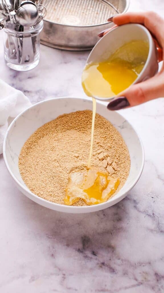 adding butter in graham cracker crumbs for cheesecake