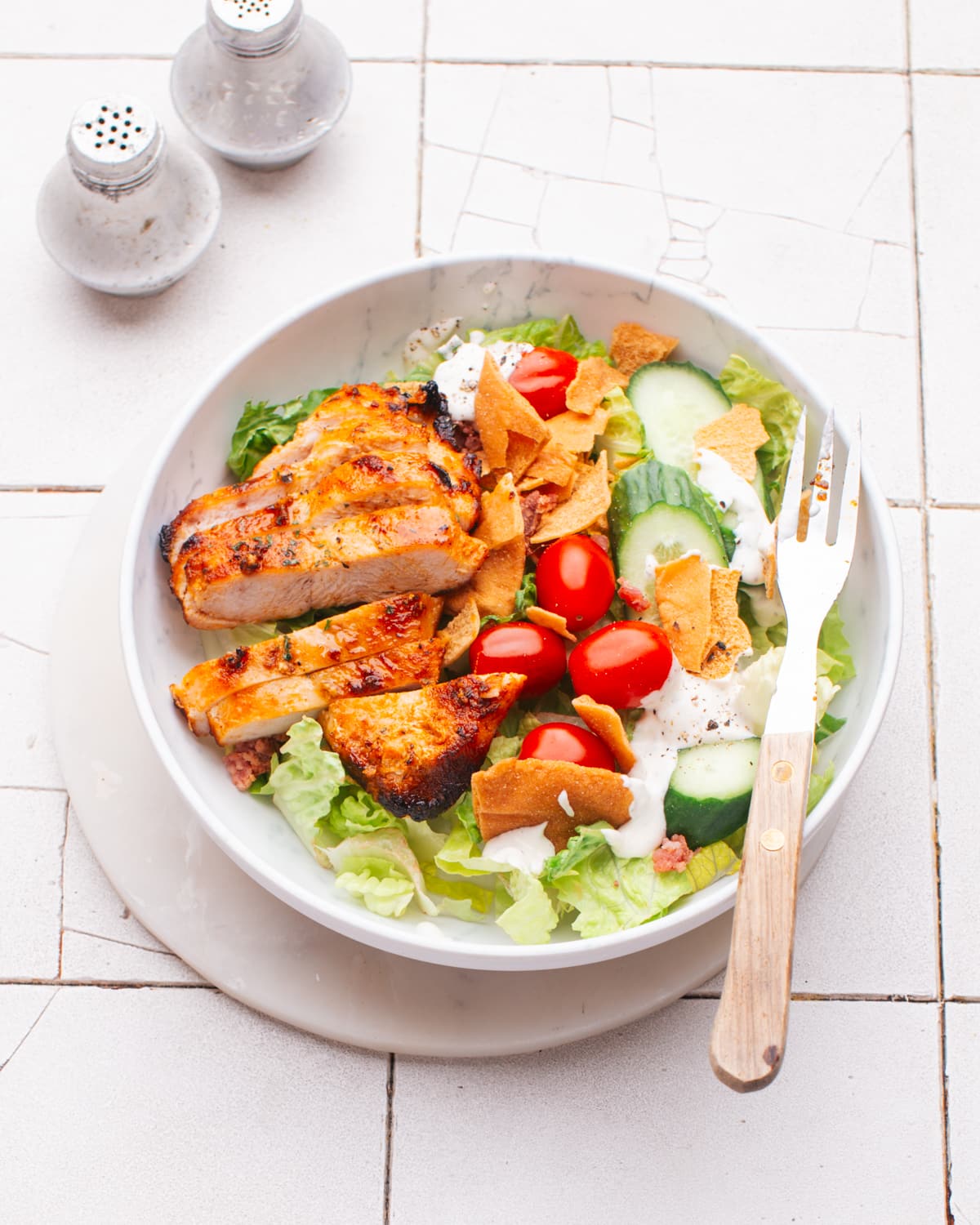 Air fryer chicken breast on a salad.