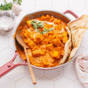 Butter paneer in a pan with naan.