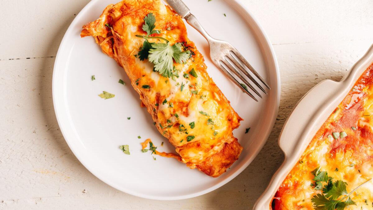 Cream Cheese Chicken Enchilada on a plate with a fork.