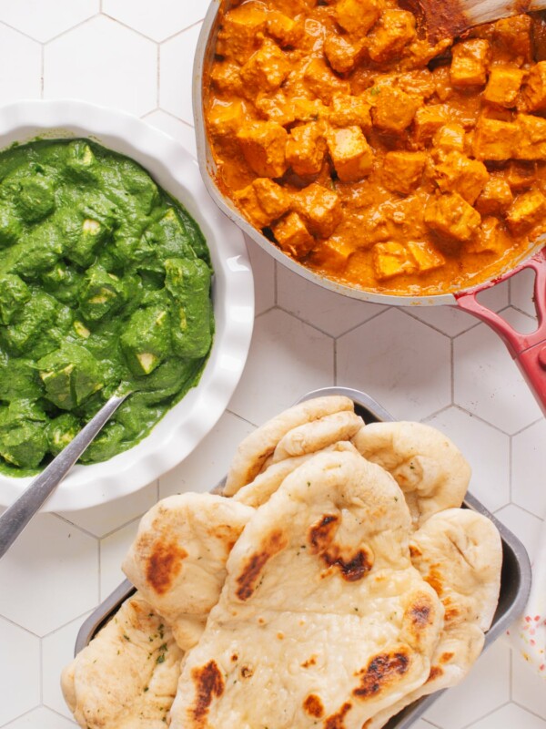 Indian dinner ideas with butter paneer with palak paneer and naan.