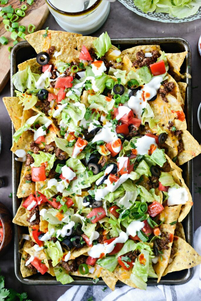 Loaded nachos with leftover taco meat and veggies