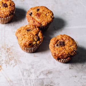 Four banana bran muffins with chocolate chips.