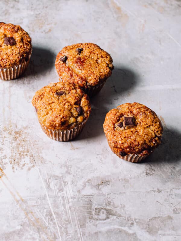 Four banana bran muffins with chocolate chips.