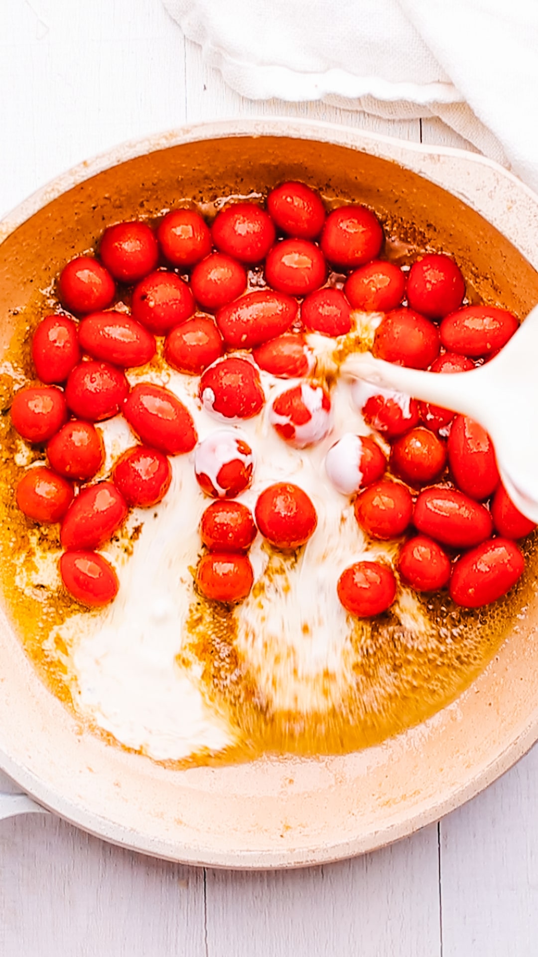 adding cream in tomatoes for gnocchi sauce