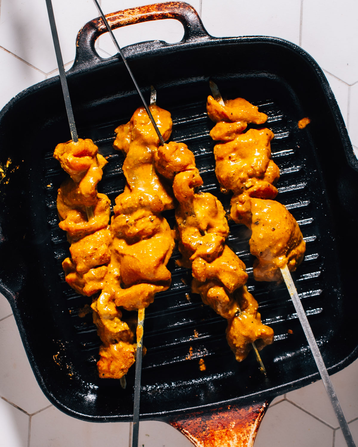 Cooking chicken kebabs.