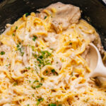 Crockpot Chicken Alfredo recipe close up shot with a spoon.