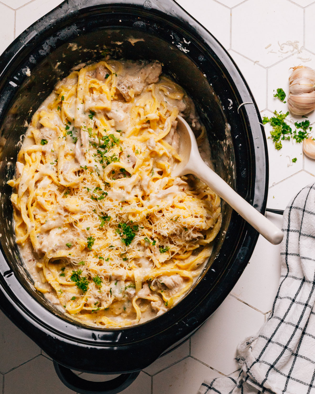 Crockpot Chicken Alfredo Recipe in slow cooker with a spoon. 
