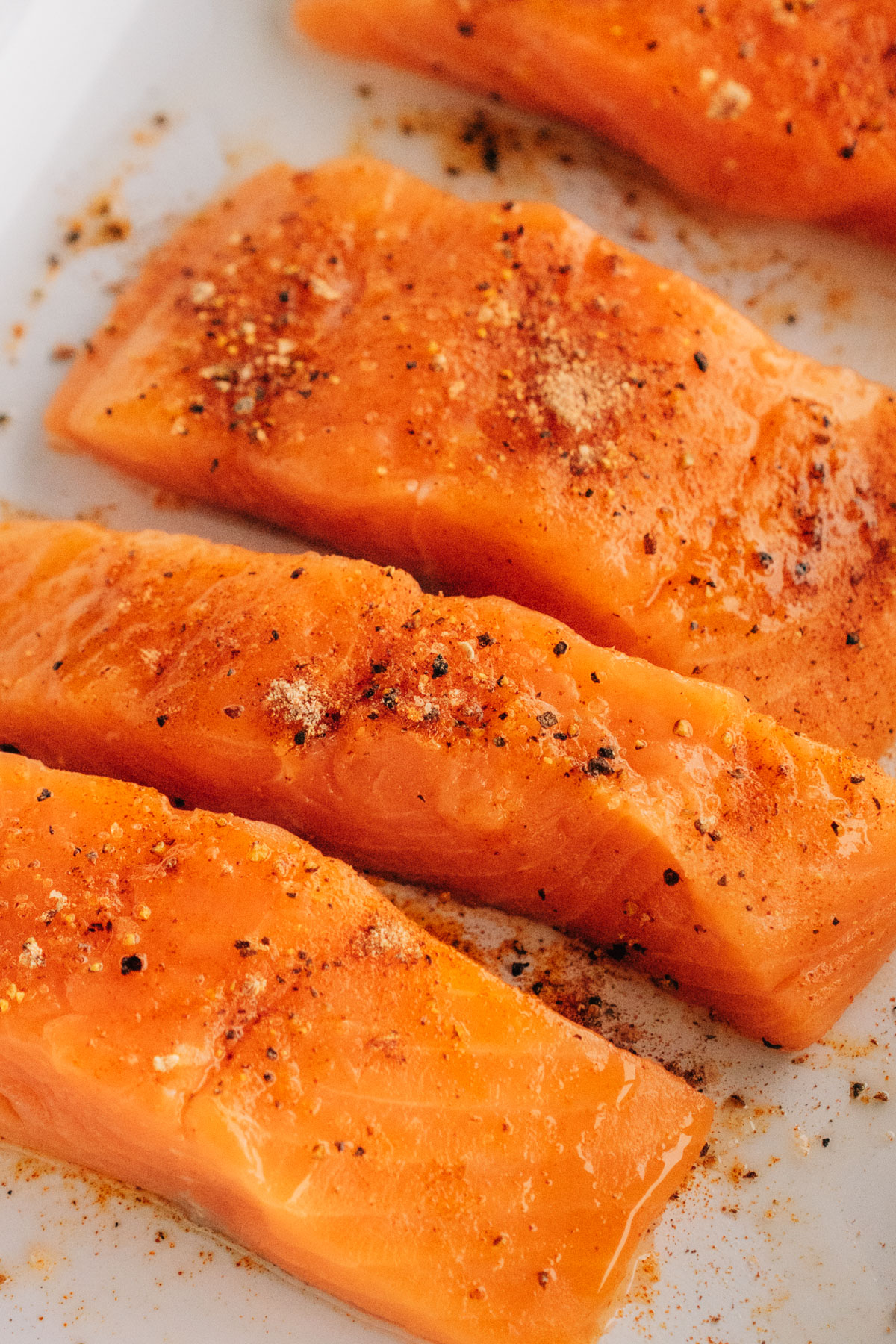 Raw salmon seasoned on a plate.