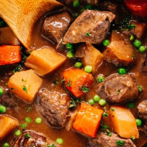 Pressure Cooker Beef Stew in Instant Pot with a wooden spoon.