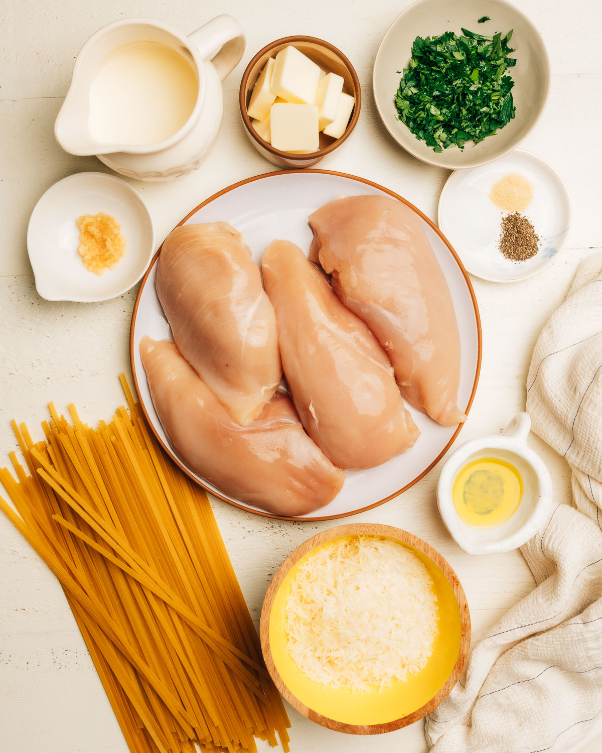 Ingredients of Chicken Alfredo laid out. 