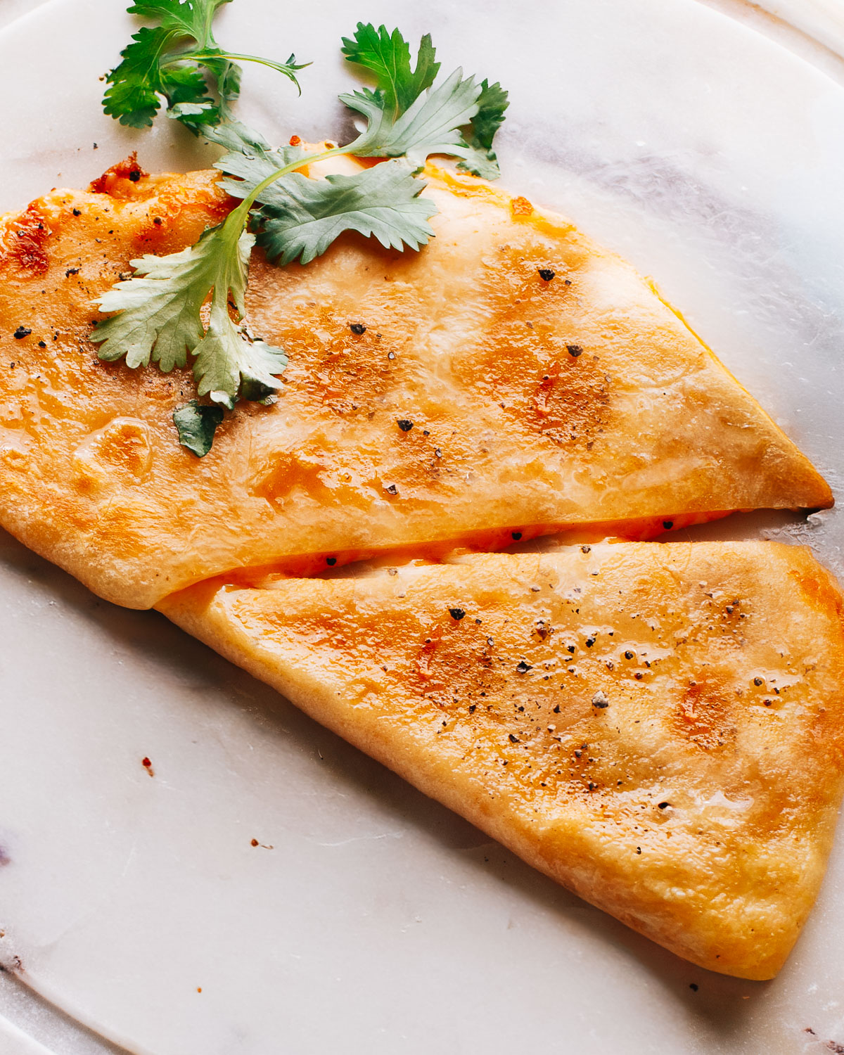 Chicken Quesadilla recipe on a marble plate.
