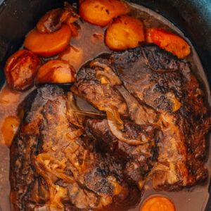 Chuck Roast in Crockpot with carrots and potatoes.