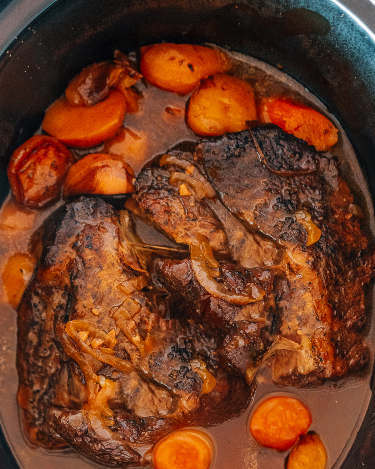 Chuck Roast in Crockpot with carrots and potatoes.