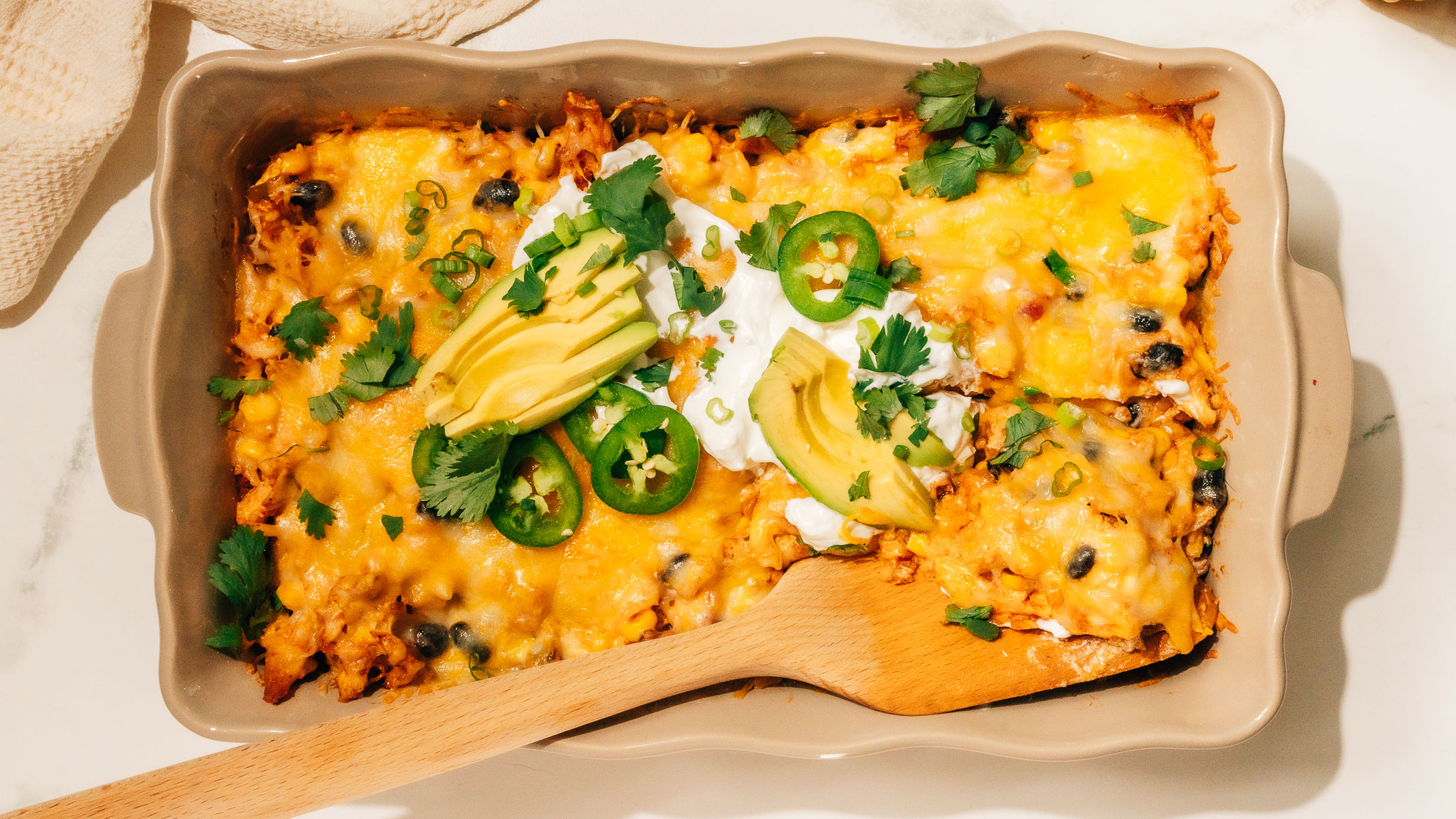 Mexican Chicken Casserole with a spatula.