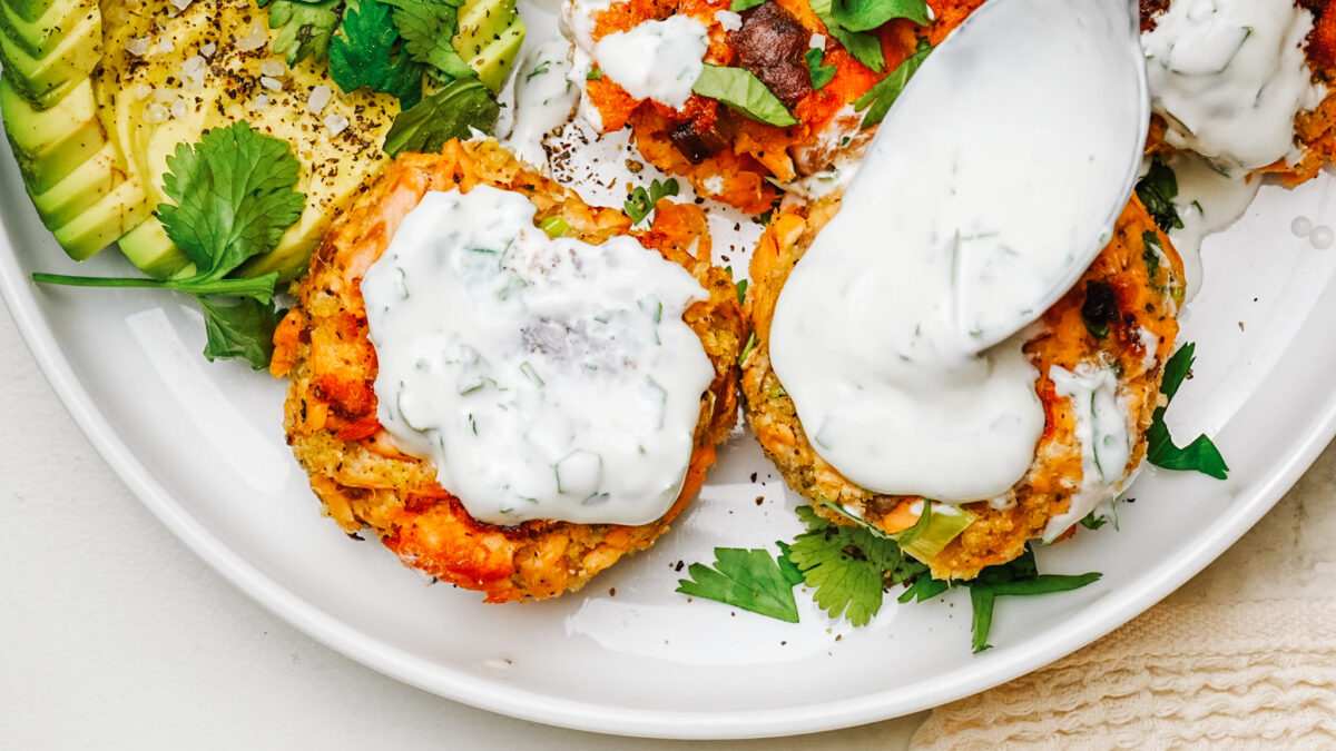 Golden salmon patties served with salad topped and served with dill sauce.
