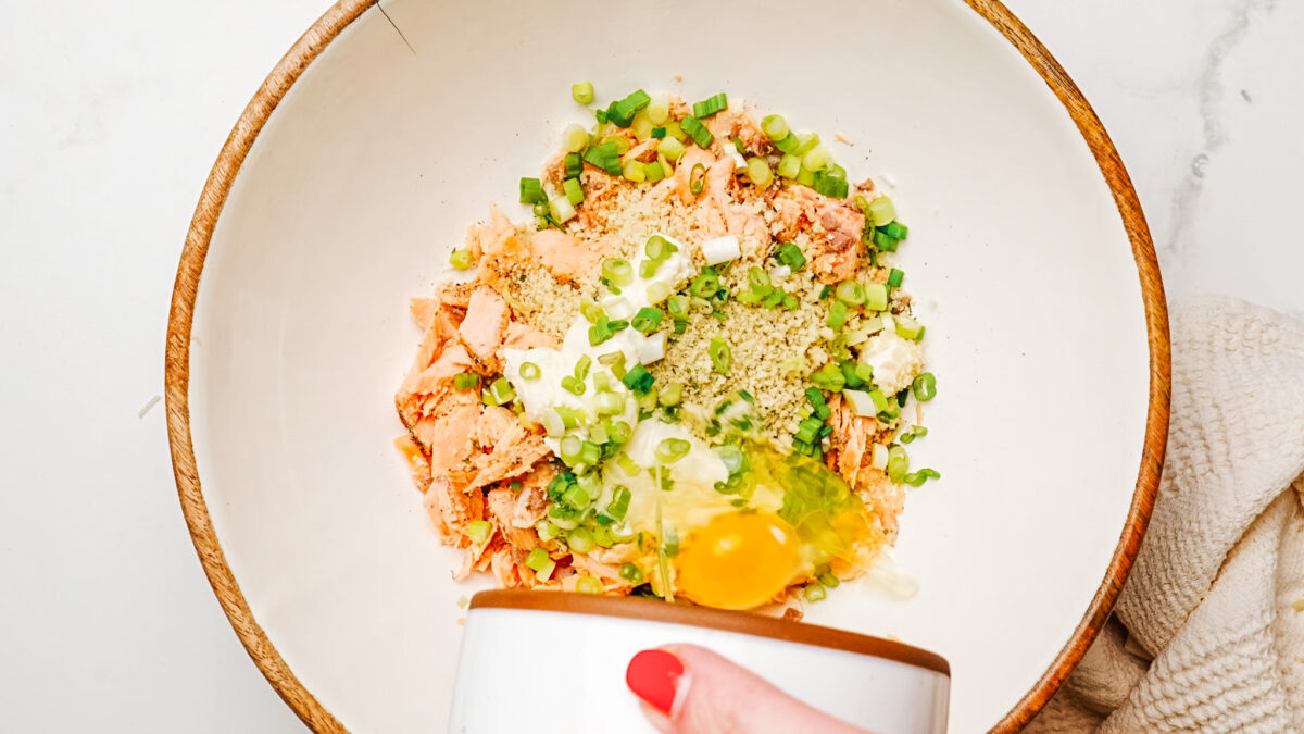 Mixing all the salmon patty ingredients in a bowl.