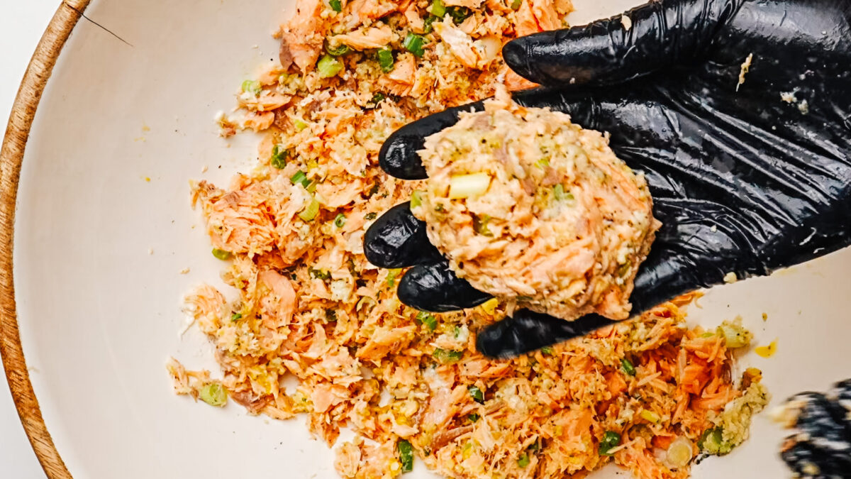 Forming salmon patties by hand.
