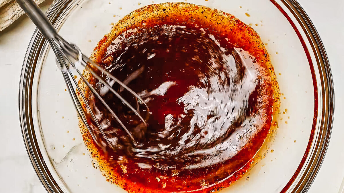 Whisking pork tenderloin ingredients together in a bowl- one of the steps in making the pork tenderloin marinade.