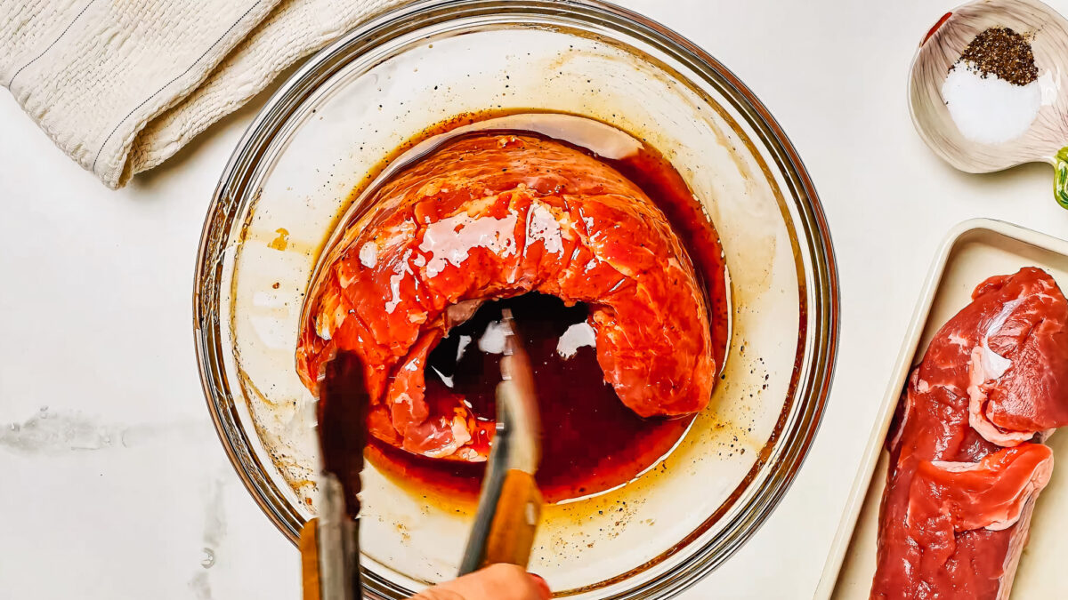Marinating the pork tenderloin in a shallow bowl with the pork tenderloin marinade.