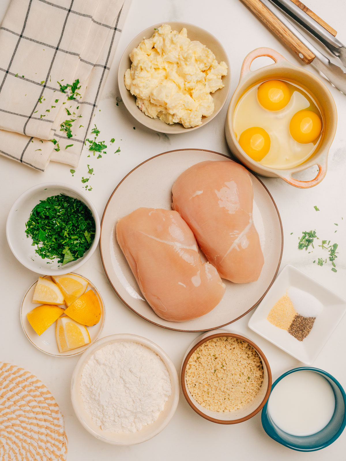 Chicken Schnitzel ingredients laid out on the counter mise en place style.