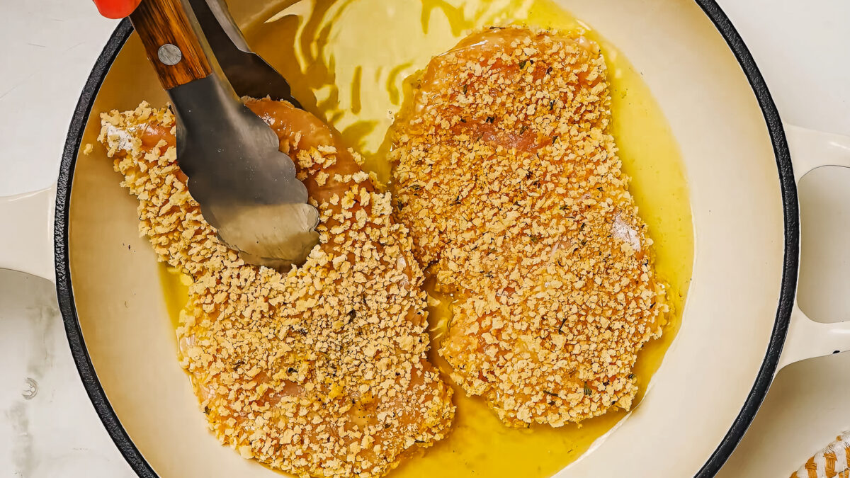 Pan fry in oil the coated chicken breast in breadcrumbs for chicken schnitzel.