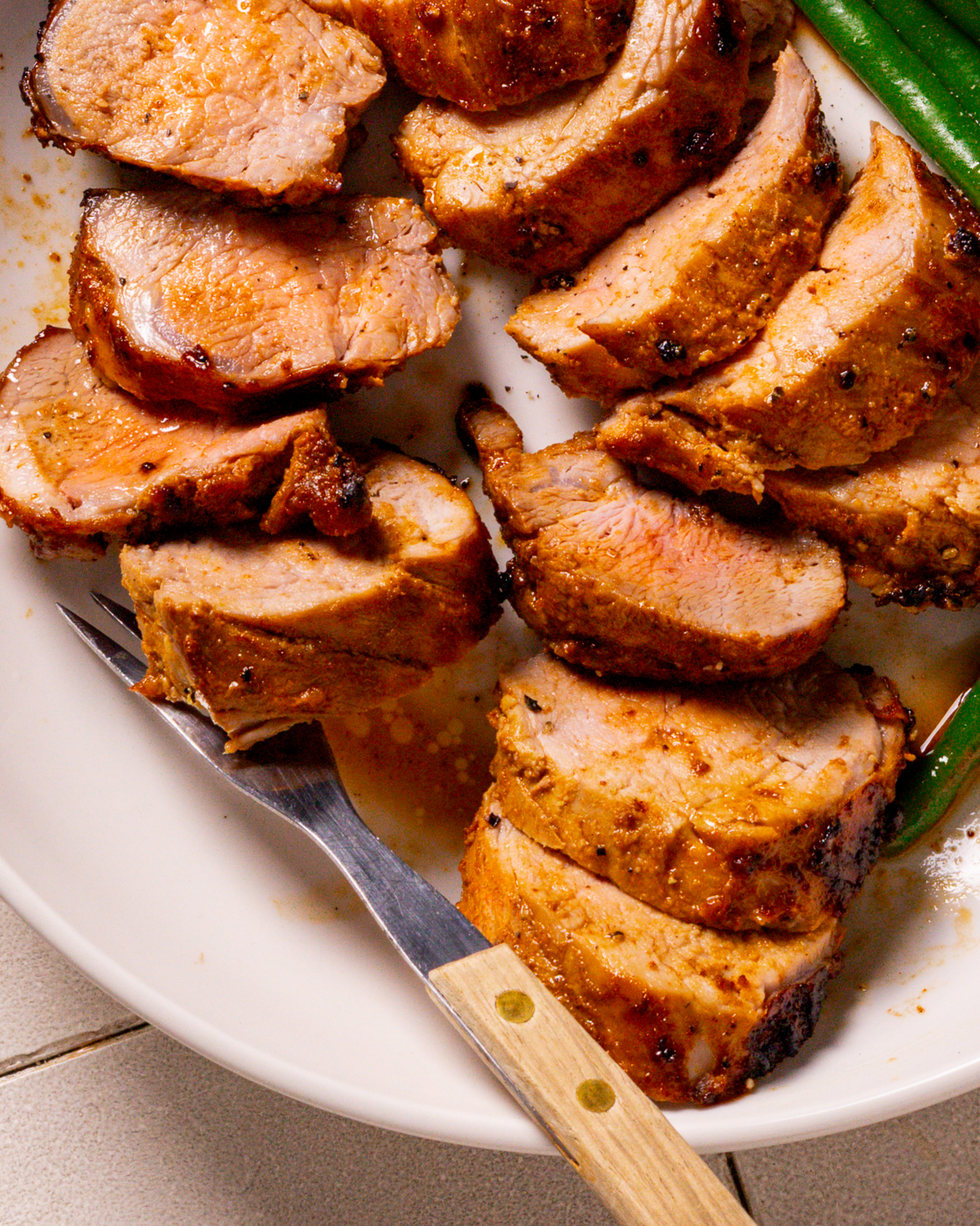 Slice Pork Tenderloin recipe on a plate.