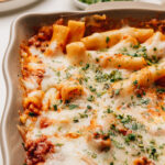 Baked ziti with ricotta topped with minced parsley.