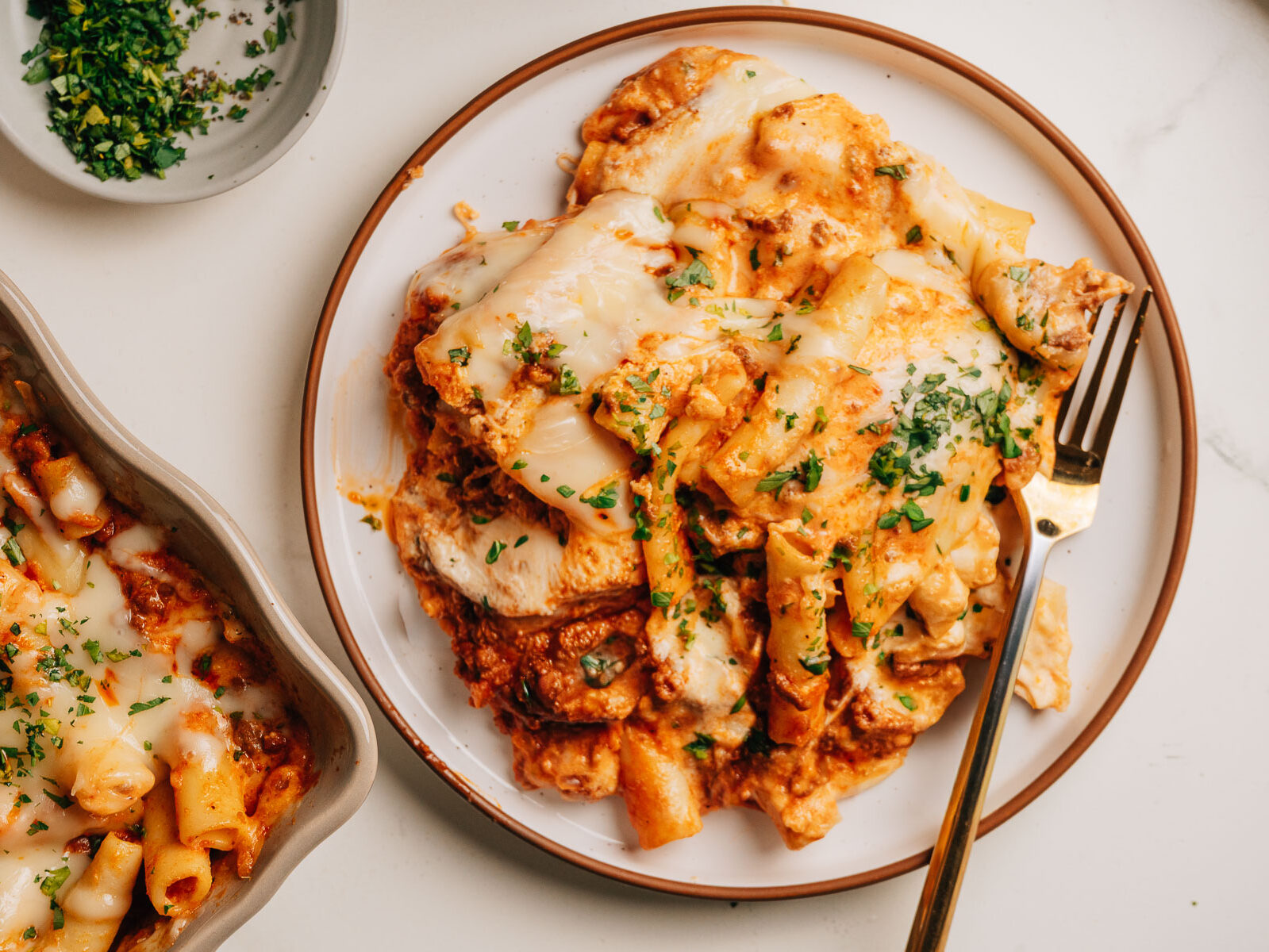 Baked ziti with ricotta topped with minced parsley.