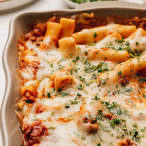 Baked ziti with ricotta topped with minced parsley.