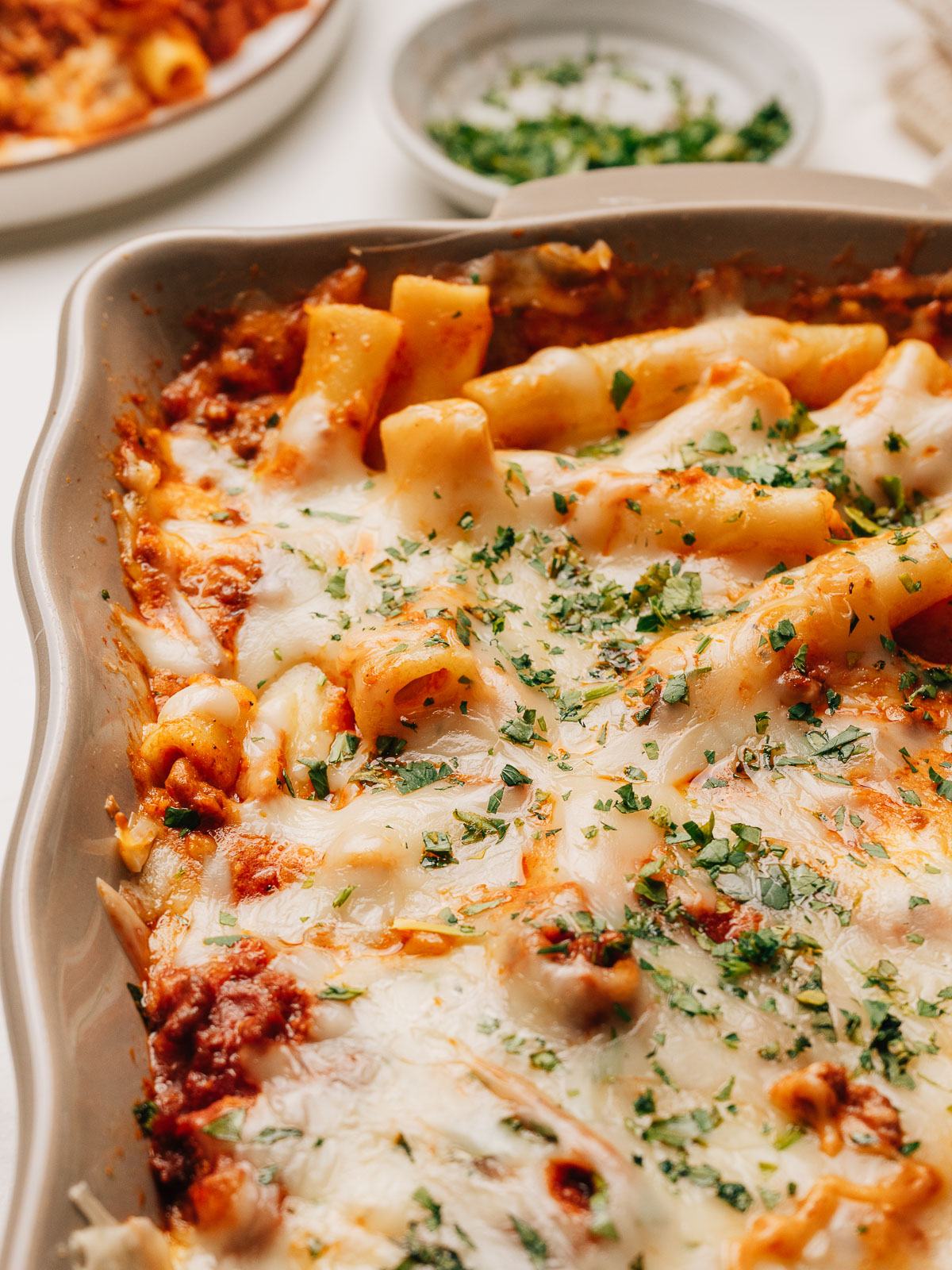 Baked Ziti with Ricotta fresh from the oven with golden bubbling cheese and fresh herbs.