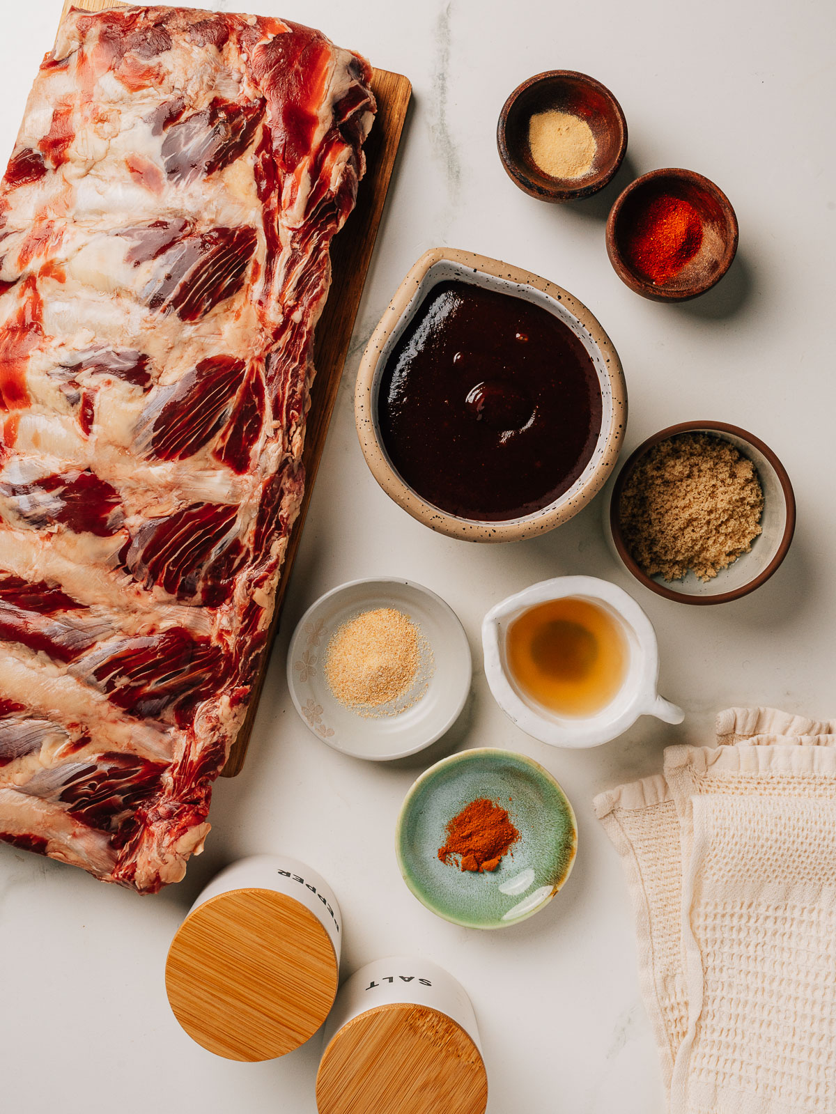 Beef back ribs recipe ingredients laid out on a cutting board.