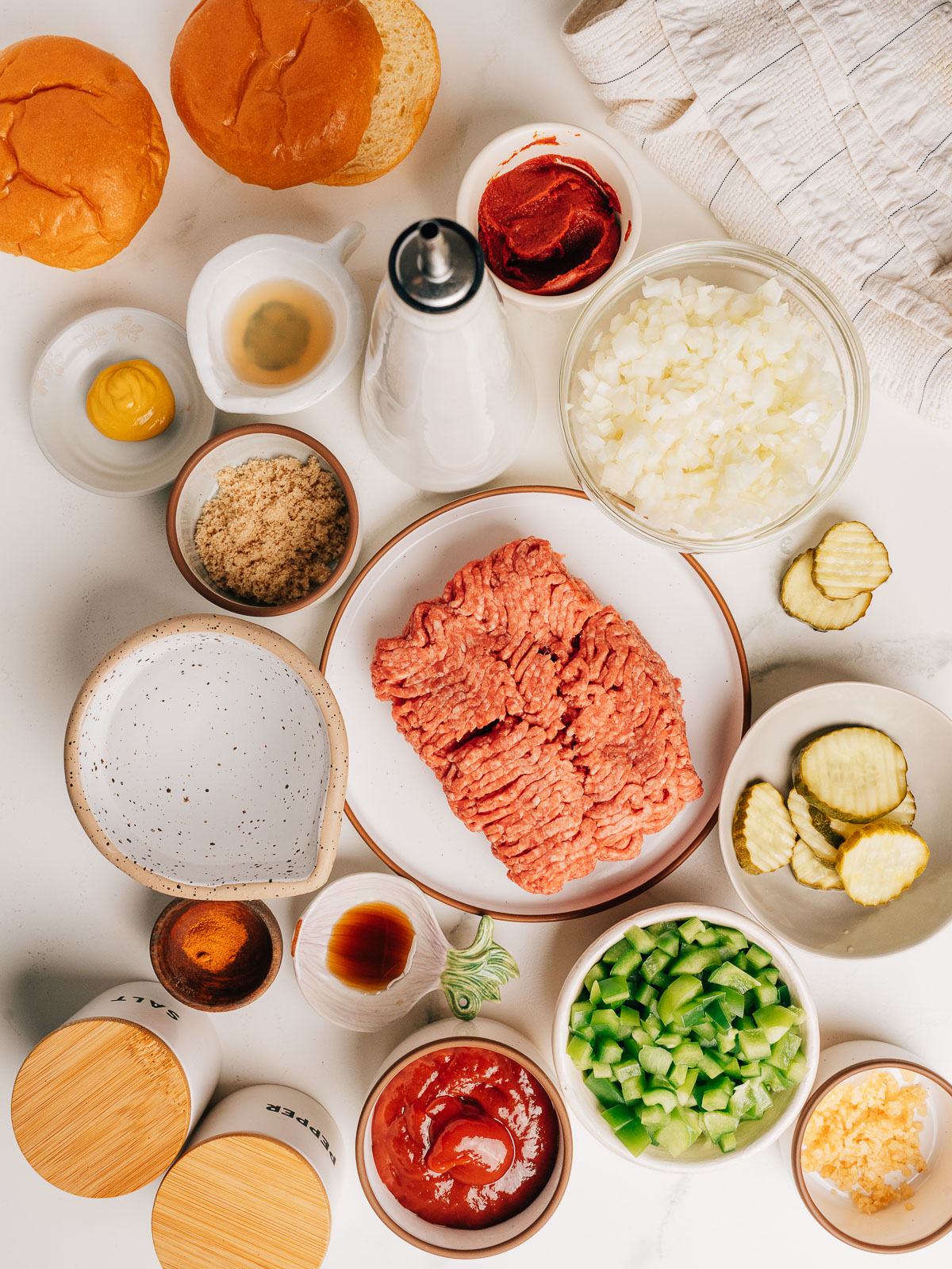 Ingredients for easy sloppy joes including ground beef, onion, bell pepper, and sauce ingredients