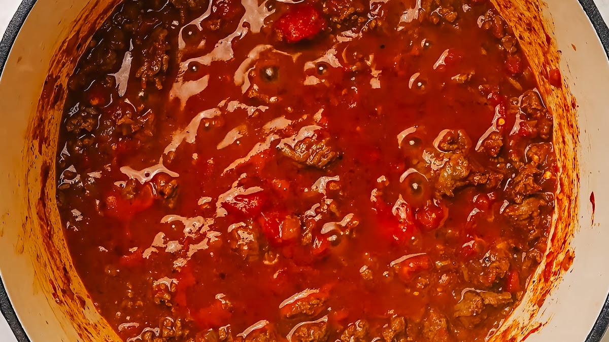 Simmering ground beef spaghetti sauce in a skillet