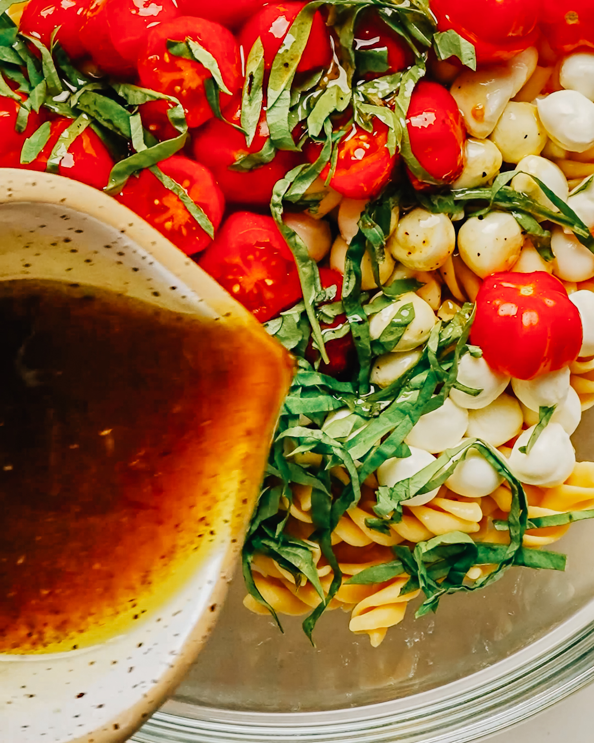 Homemade balsamic vinaigrette dressing being poured out.