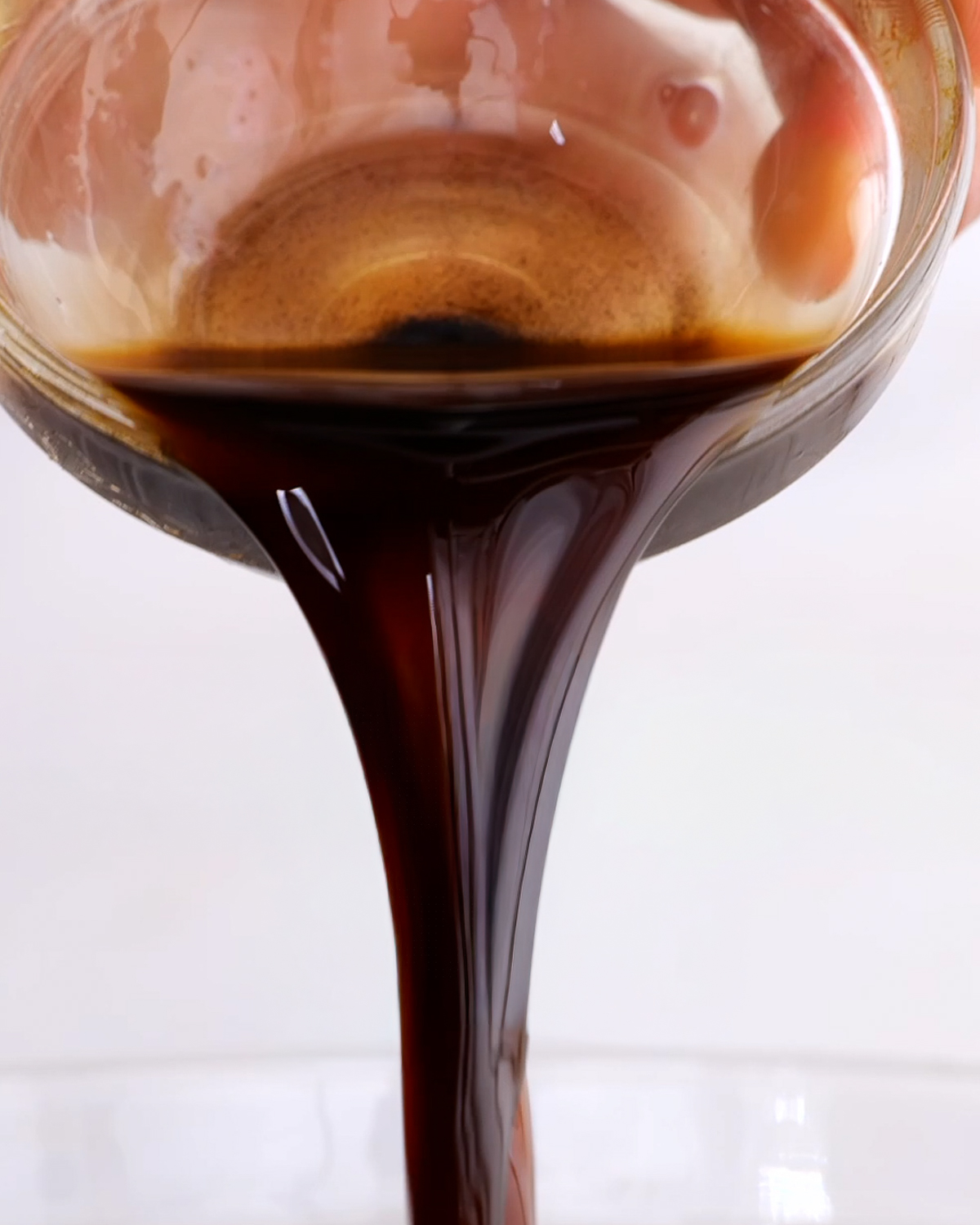 Homemade balsamic vinaigrette dressing being poured out.