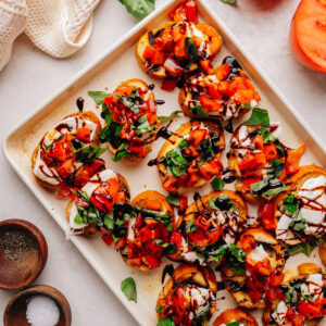 Overhead tray of bruschetta with mozzarella, tomato and basil.