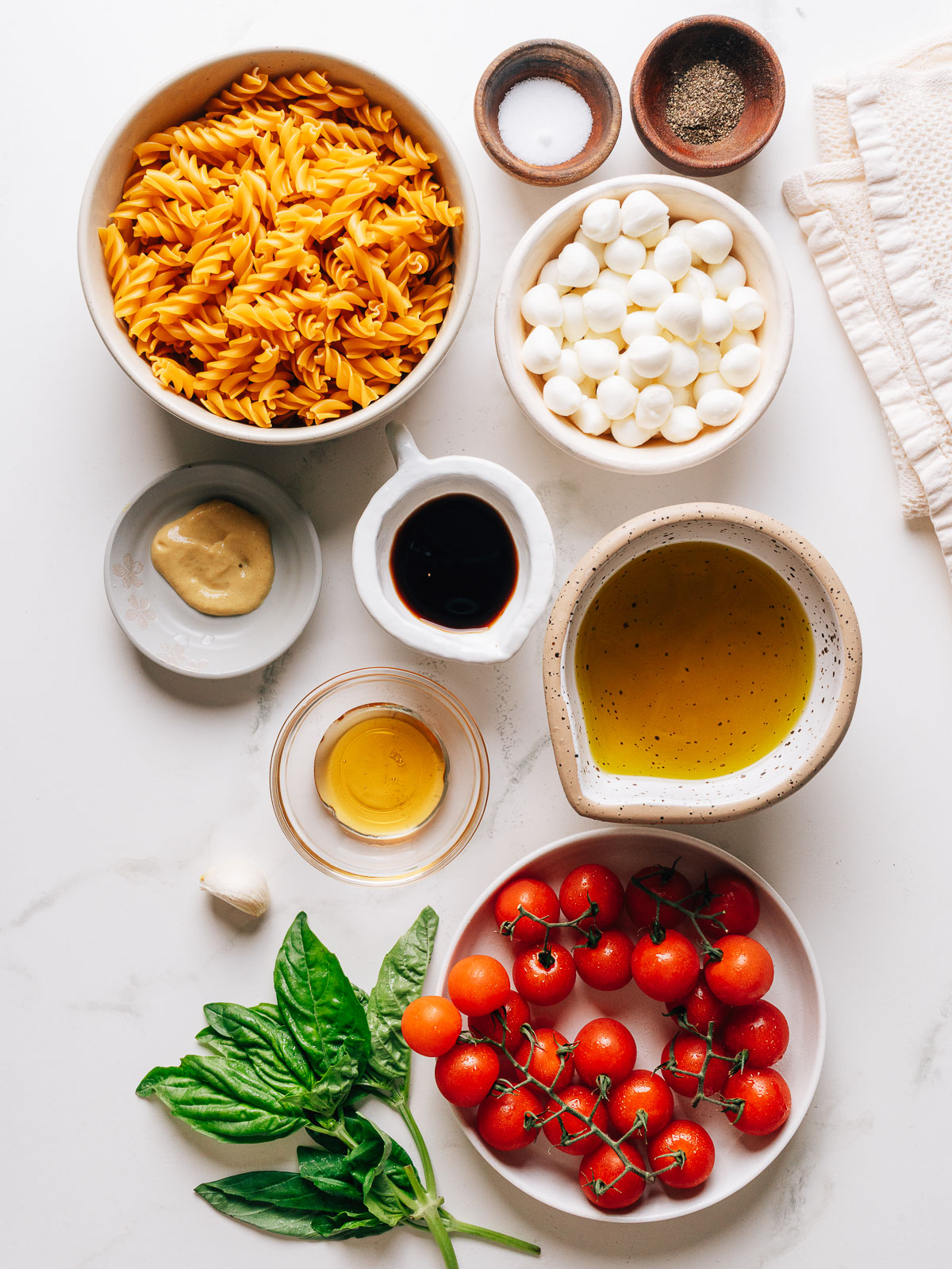 Caprese pasta salad ingredients on a countertop.