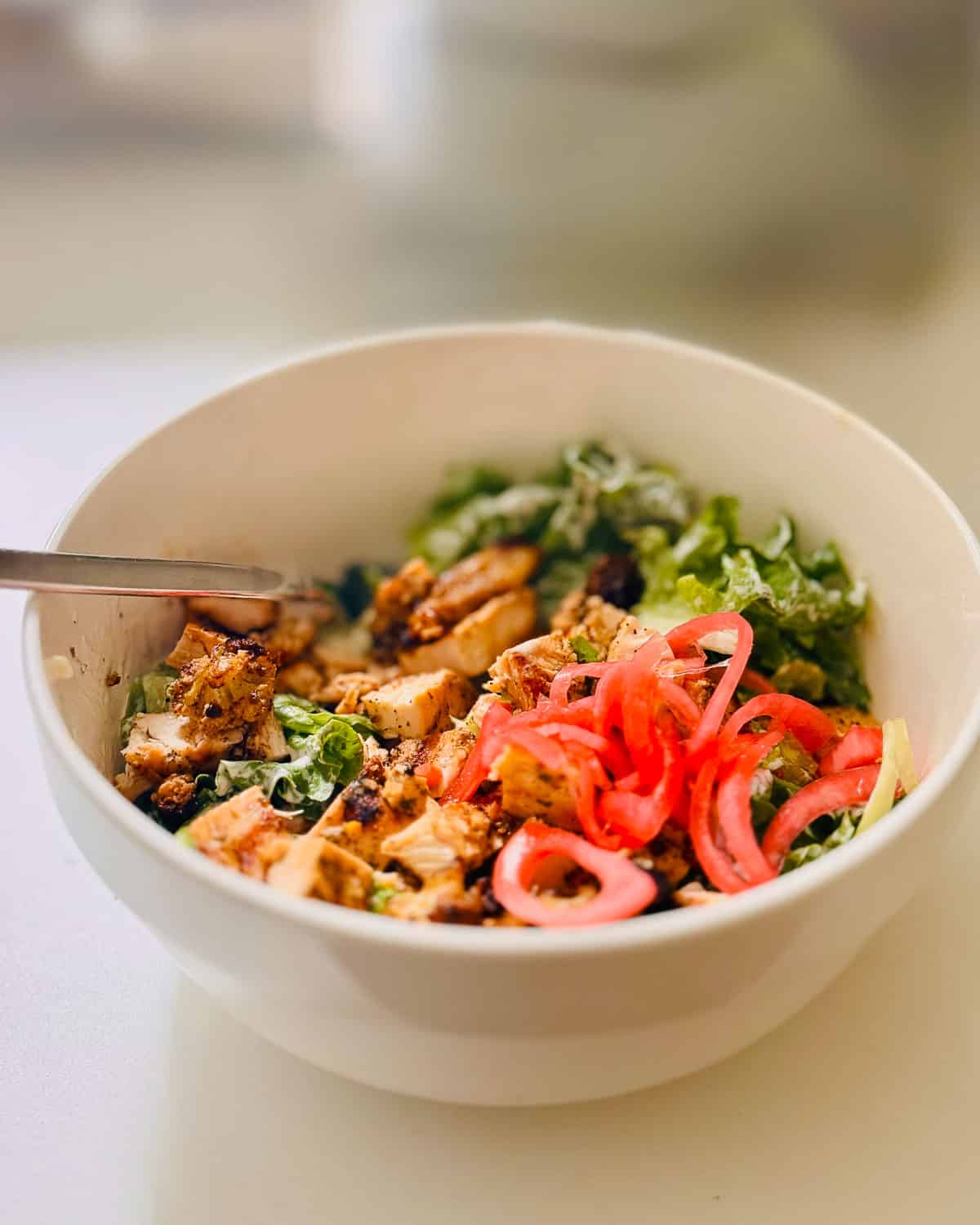 Dijon vinaigrette poured over a fresh green salad.