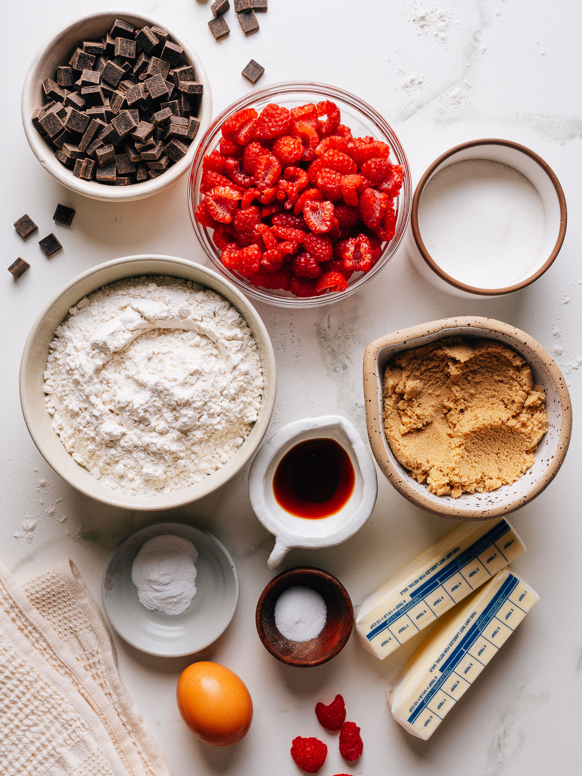 Ingredients for raspberry cookies including butter, flour, sugar, and fresh raspberries.