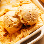 Scoops of homemade peanut butter ice cream in a container.