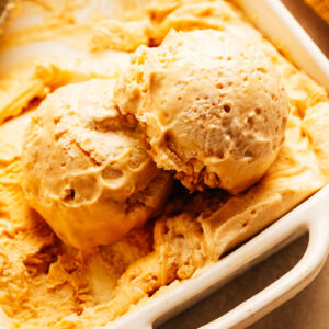 Scoops of homemade peanut butter ice cream in a container.