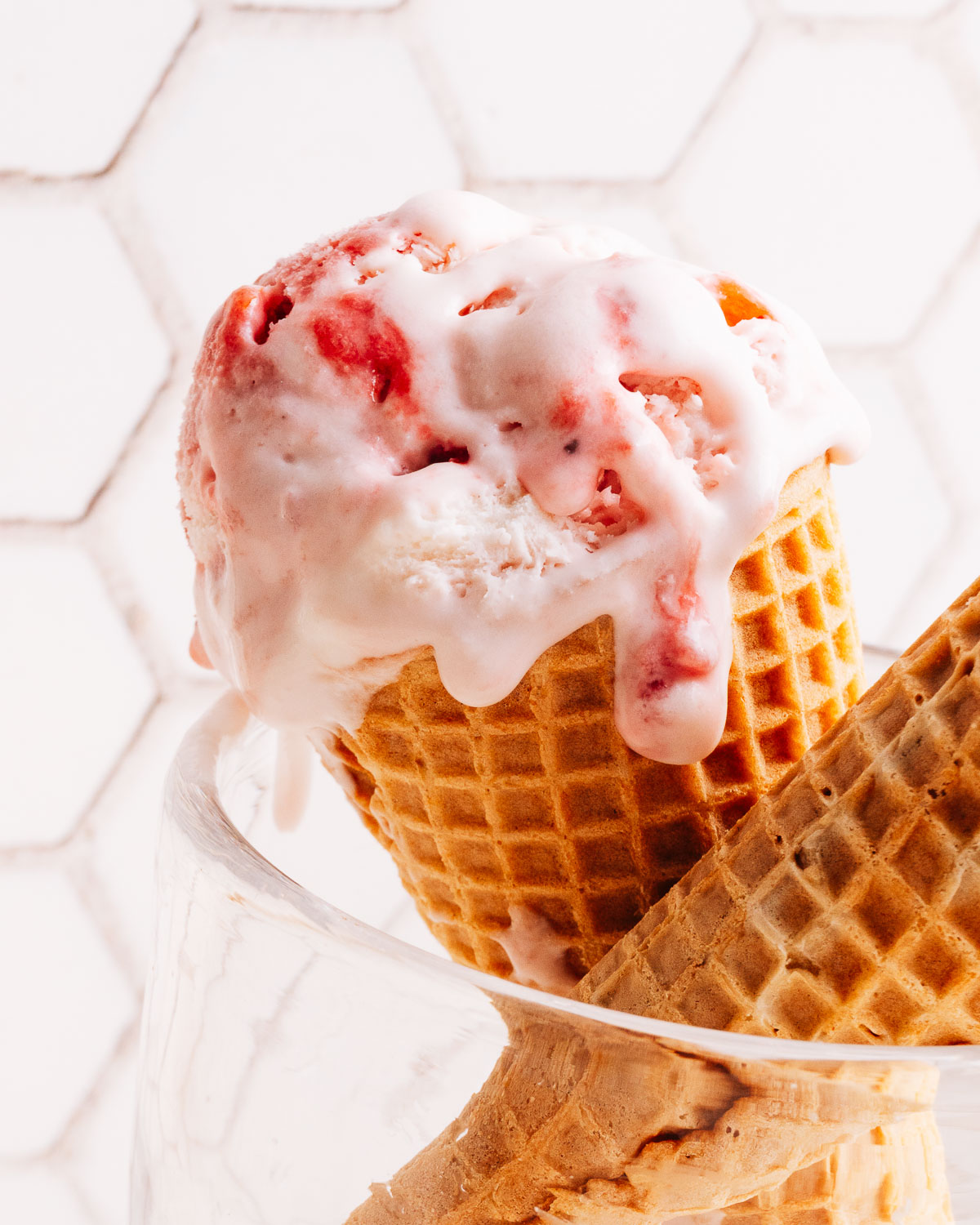 Scoop of homemade strawberry ice cream in a cone.