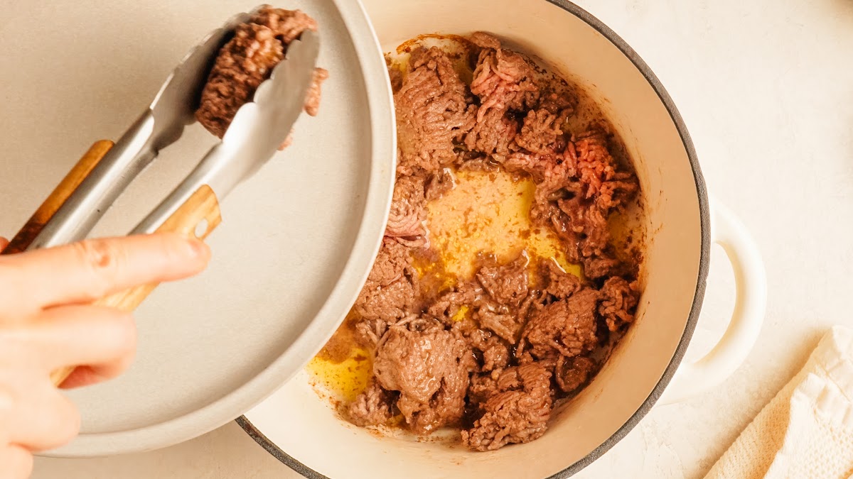 Step 1: ground beef browned in a Dutch oven for pizza bowls.