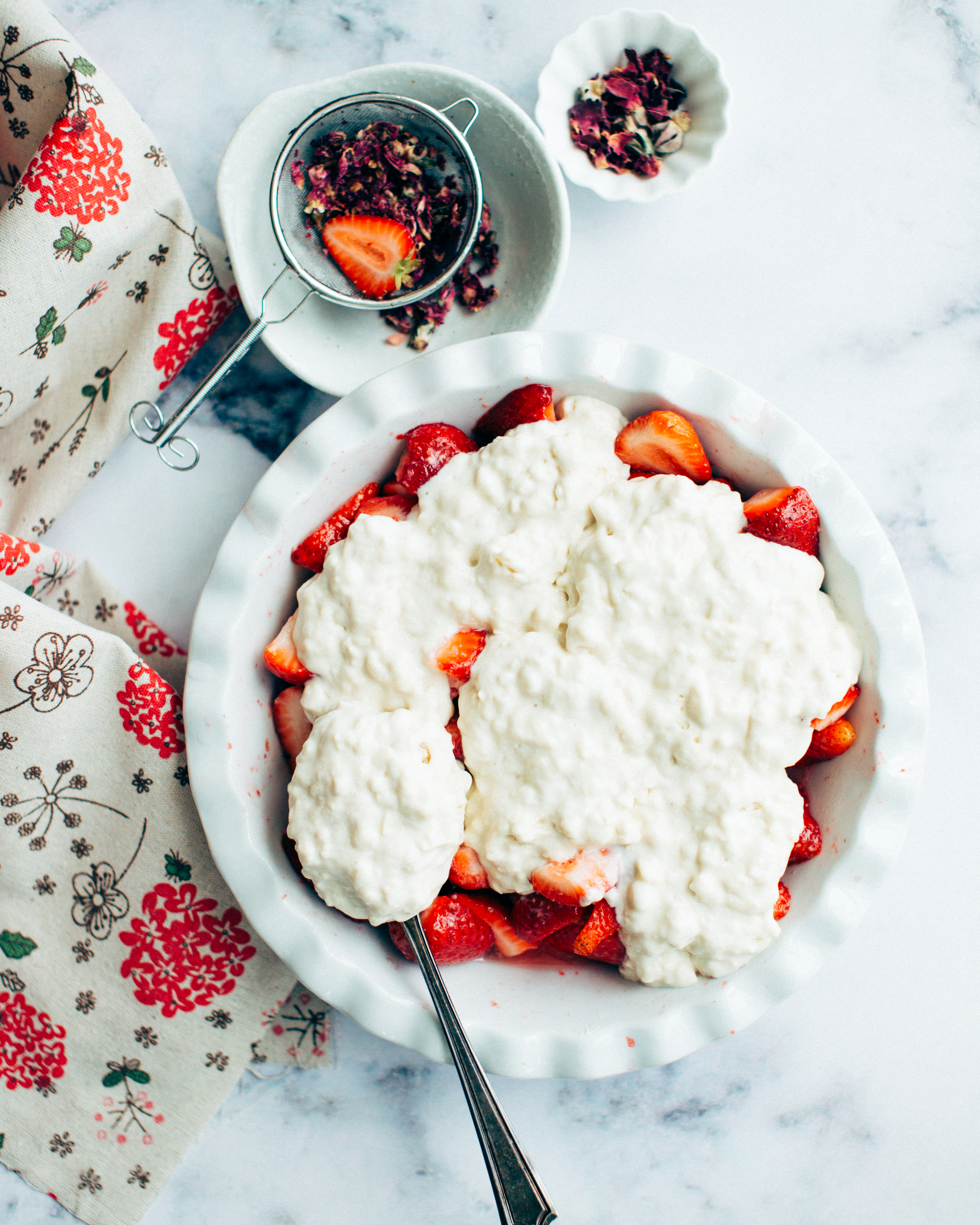 The unbaked strawberry cobbler in a baking dish.